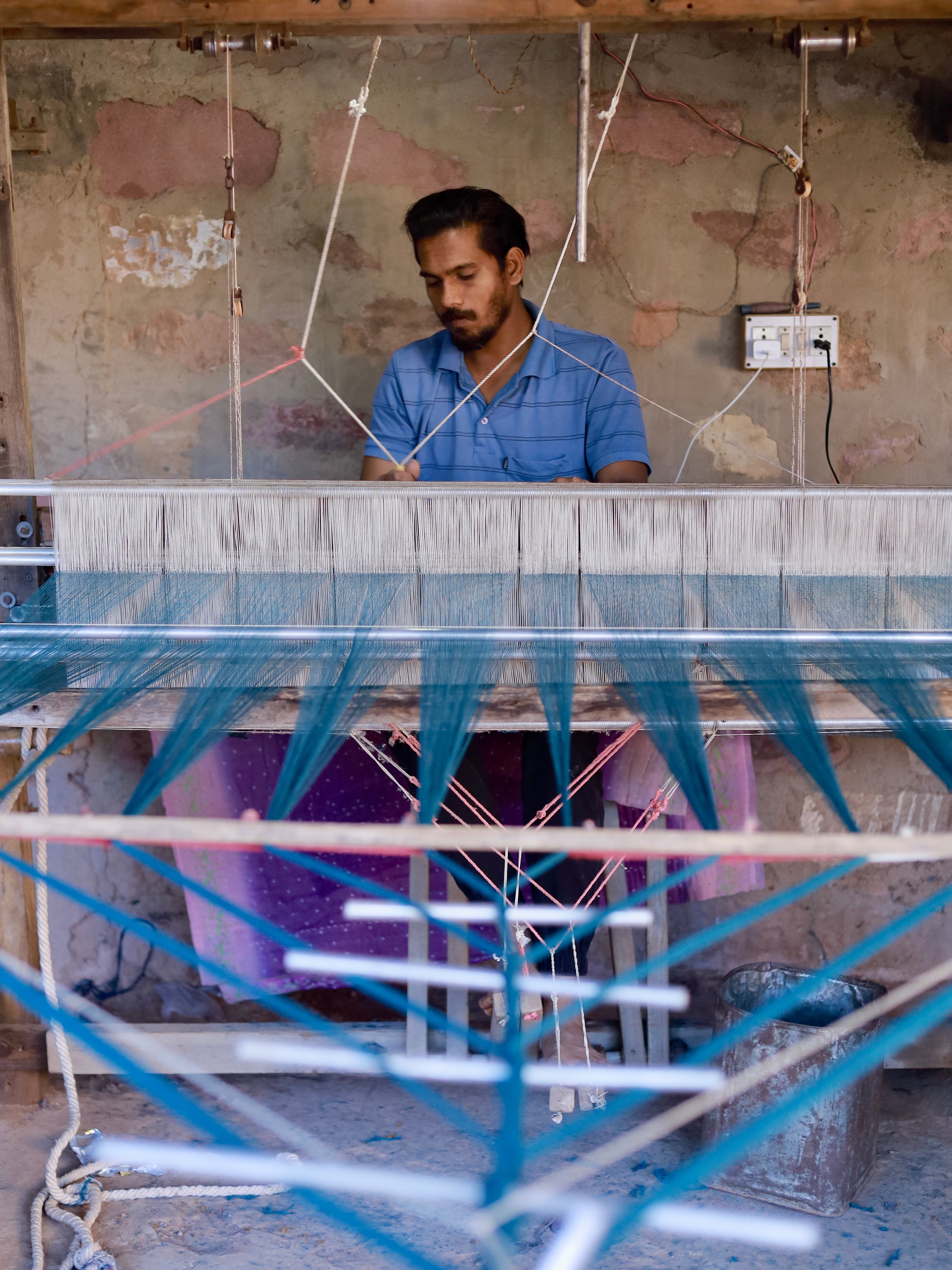 Our master weaver focused at his loom, crafting intricate textiles with care—an essential part of Mareen’s slow, human-centered process.
