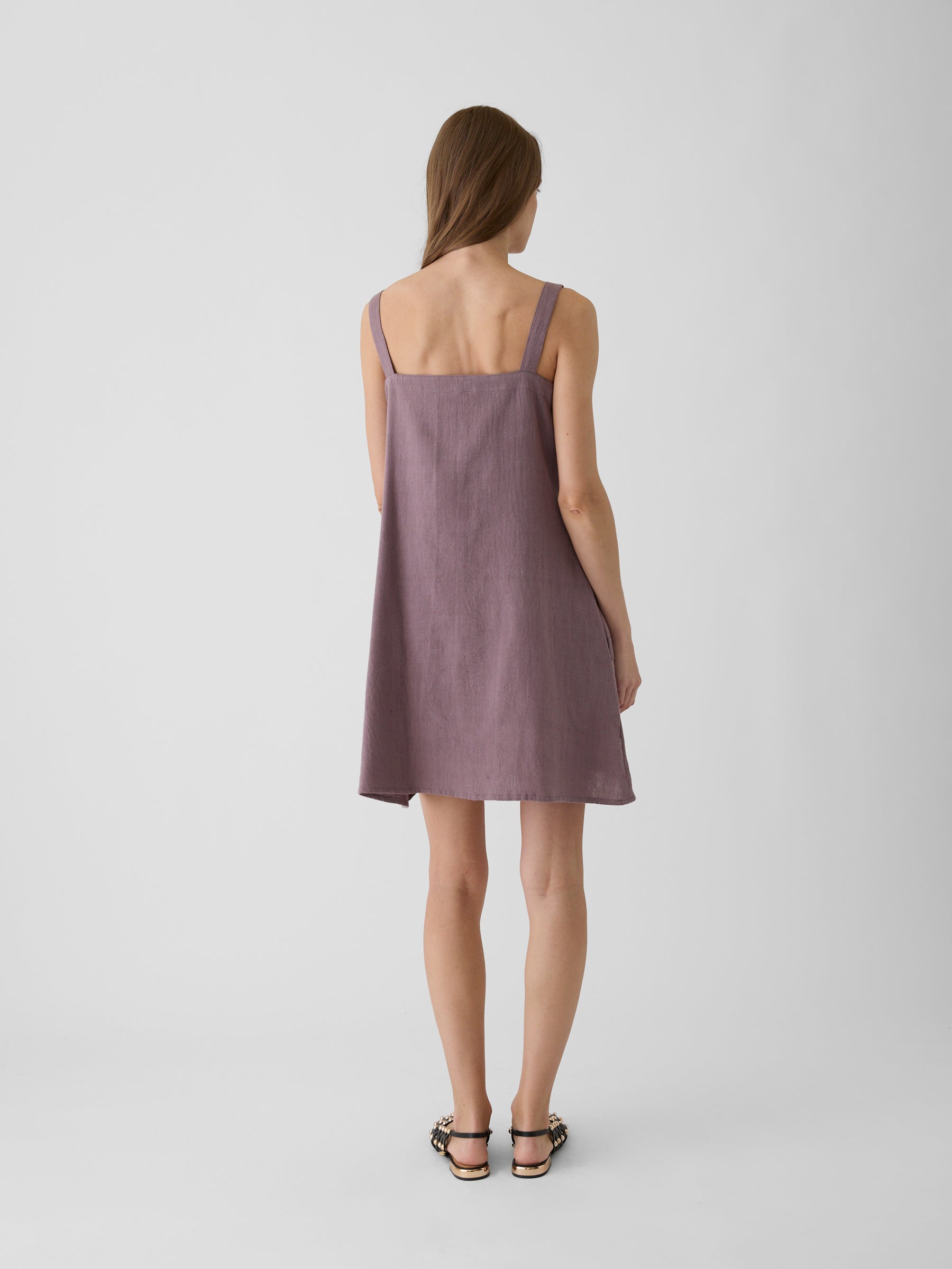 Woman wearing a mauve short dress back